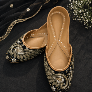 Black Punjabi jutti with gold embroidery and pearl embellishments